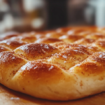 Rolling out cinnamon focaccia dough with cinnamon-sugar mixture.